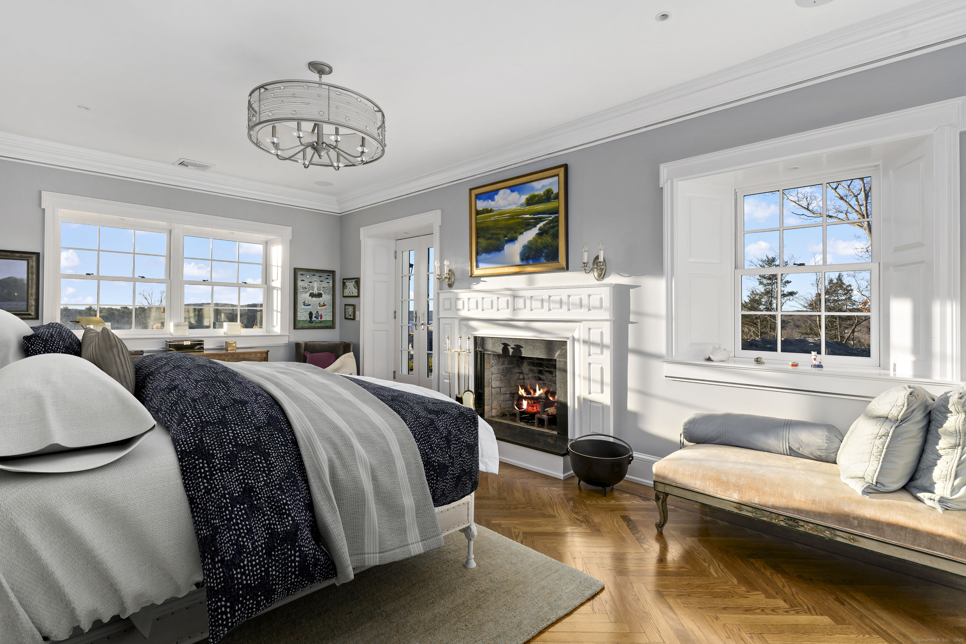 153 Ferry Road Lyme, CT 06371 - Photo 27 of 32 a spacious bedroom with a bed and a fireplace