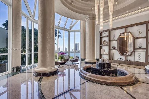 a living room with fireplace furniture and a large window