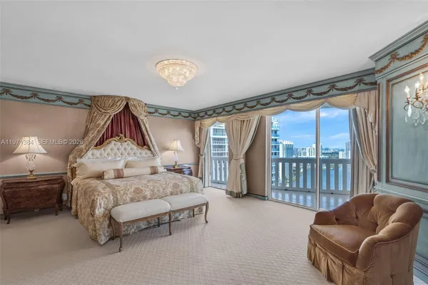 a spacious bedroom with a bed and a chandelier