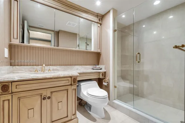 a spacious bathroom with a granite countertop sink a mirror and a bathtub