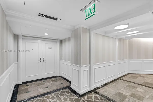 a living room with furniture and a dining table with chairs