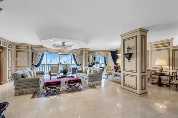 a living room with couches and a dining table with wooden floor