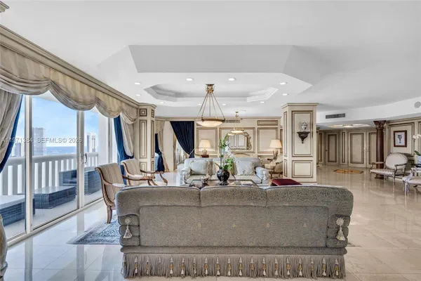 a living room with furniture a window and a table