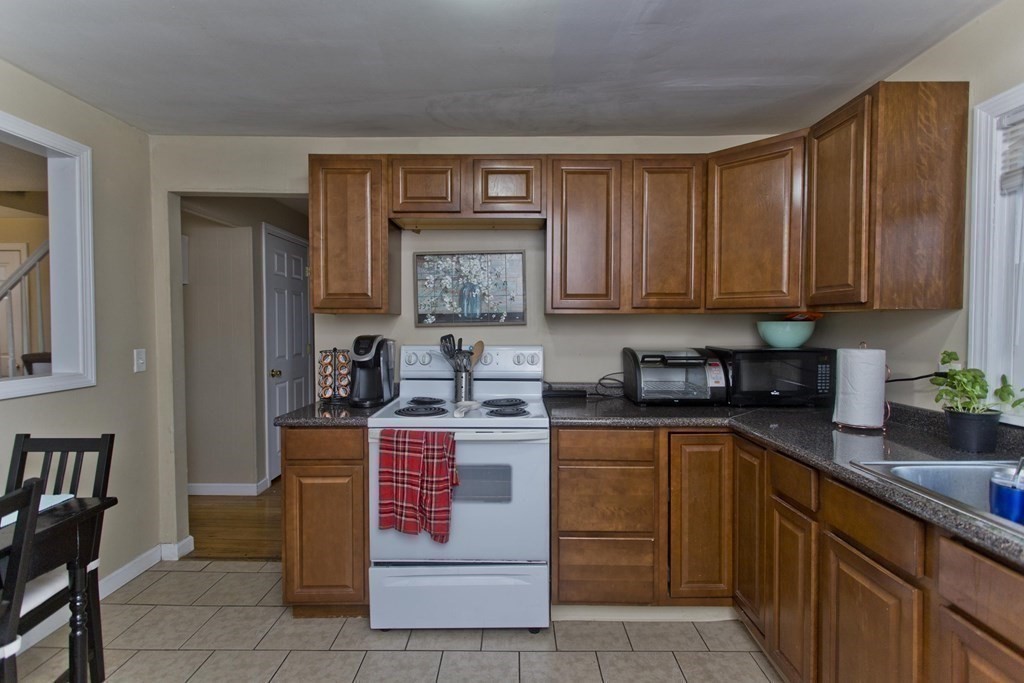 90 Spear Road Springfield, MA 01119 - Photo 3 of 19 a kitchen with stainless steel appliances granite countertop a stove sink and cabinets