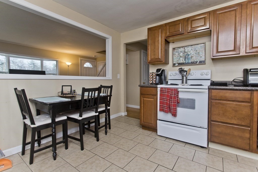 90 Spear Road Springfield, MA 01119 - Photo 4 of 19 a kitchen with a stove a table and chairs