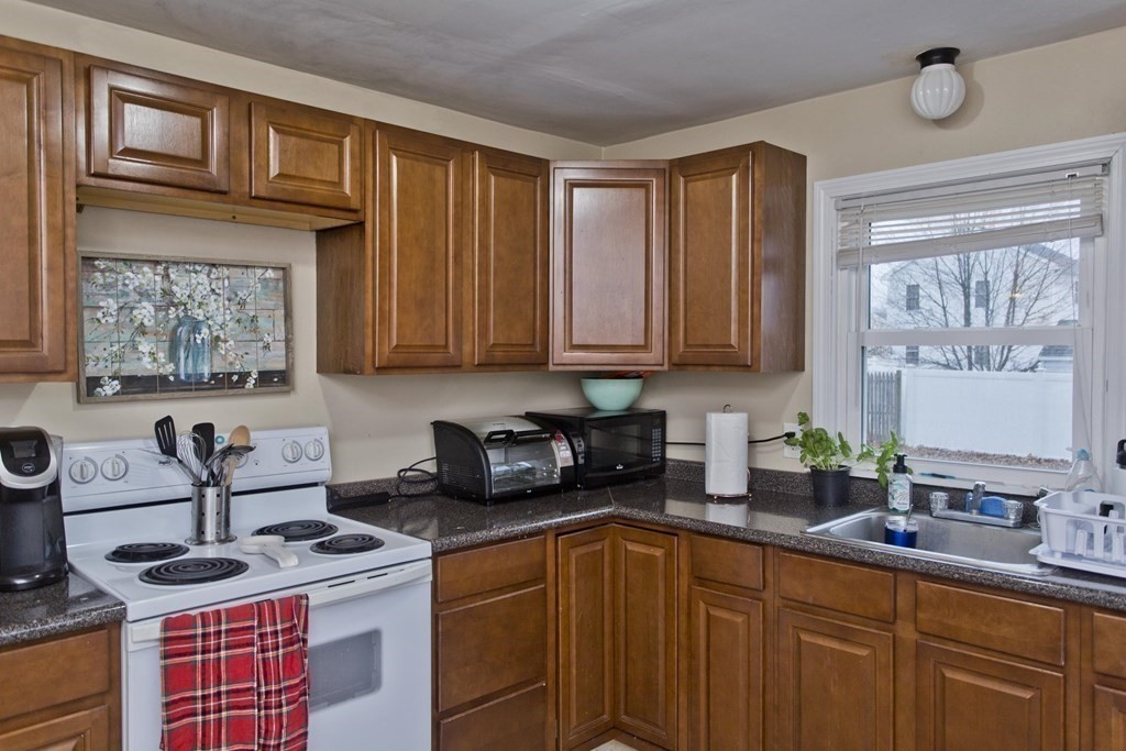 90 Spear Road Springfield, MA 01119 - Photo 6 of 19 a kitchen with stainless steel appliances granite countertop a sink stove and cabinets