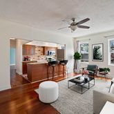 a living room with furniture a wooden floor and a chandelier