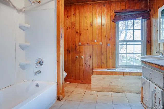 a view of a room with wooden floor and a window