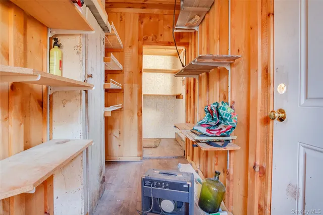 a room with exposed pipes and a window