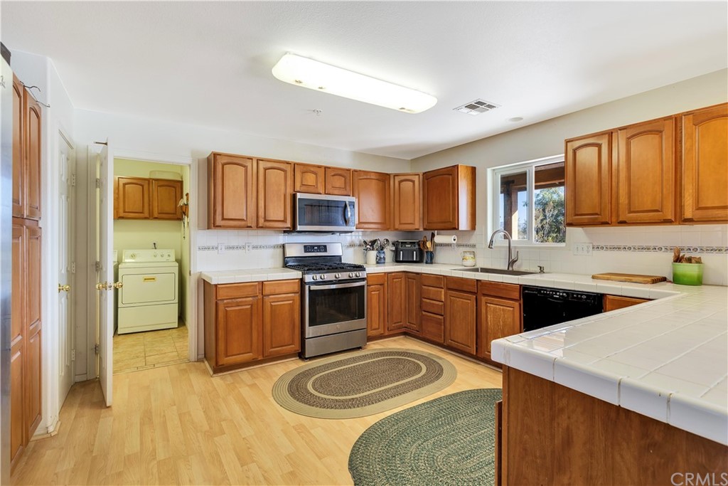62401 Sunflower Road Joshua Tree, CA 92252 - Photo 11 of 75 a kitchen with a sink stove top oven and microwave