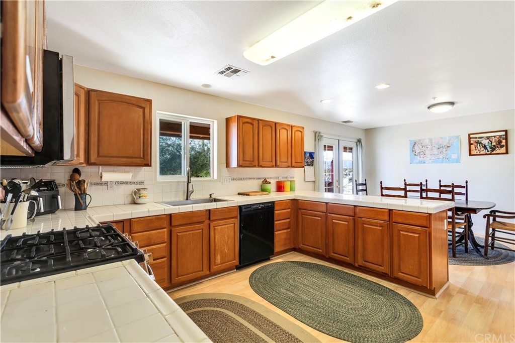 62401 Sunflower Road Joshua Tree, CA 92252 - Photo 12 of 75 a large kitchen with stainless steel appliances granite countertop a sink stove and refrigerator