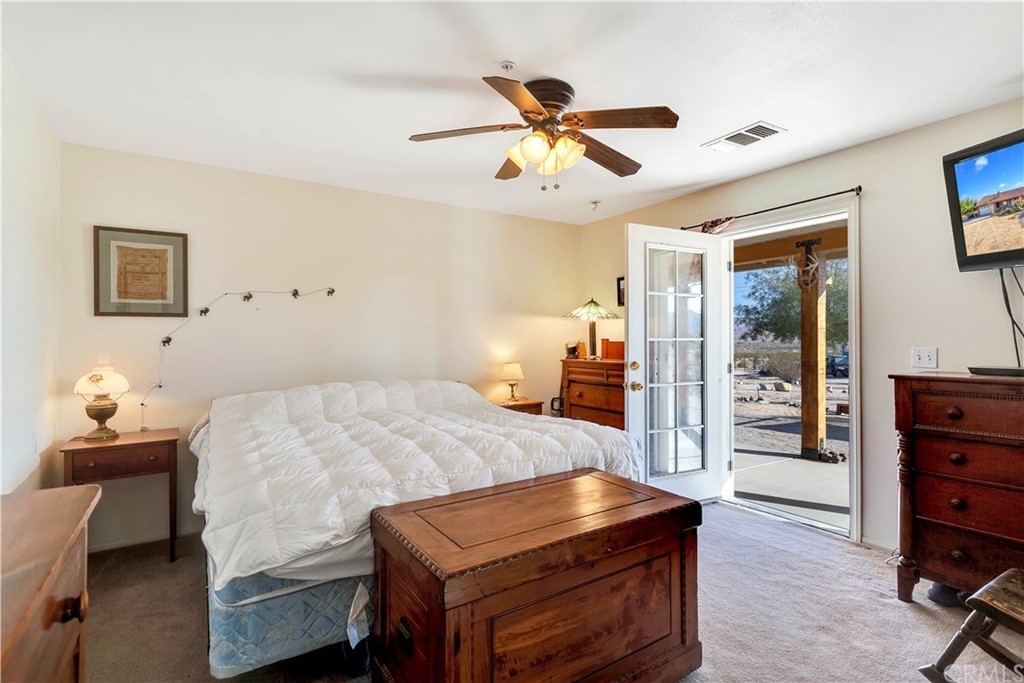62401 Sunflower Road Joshua Tree, CA 92252 - Photo 15 of 75 a bedroom with a bed and furniture