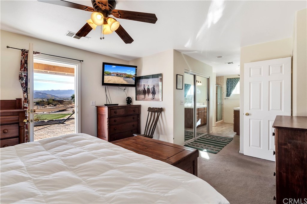 62401 Sunflower Road Joshua Tree, CA 92252 - Photo 16 of 75 a bedroom with a bed and wooden floor