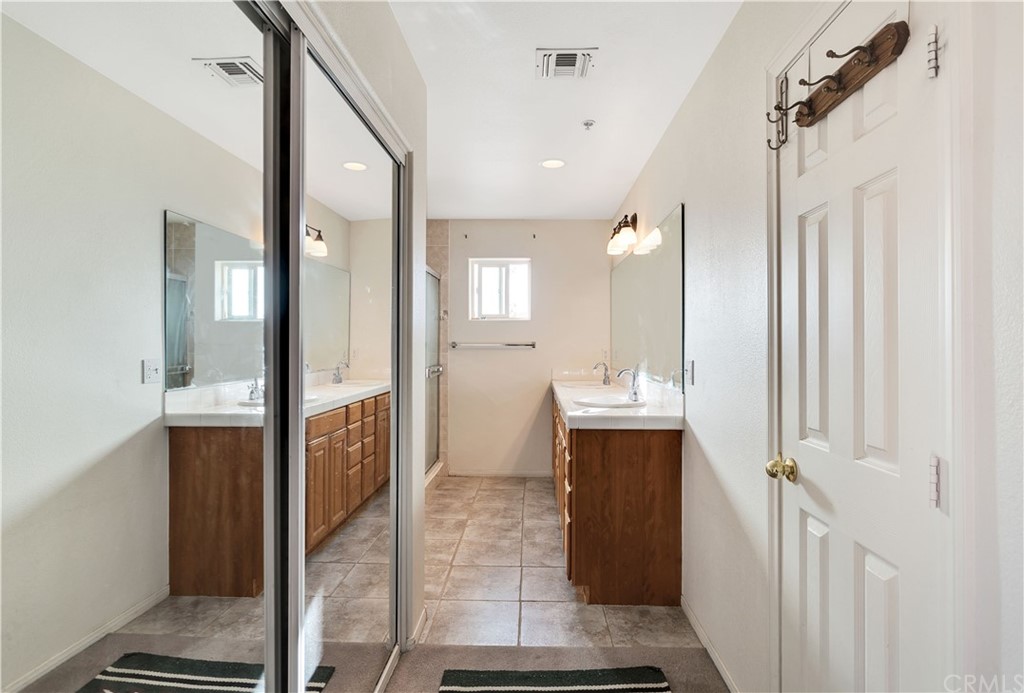 62401 Sunflower Road Joshua Tree, CA 92252 - Photo 17 of 75 a bathroom with a double vanity sink mirror and shower