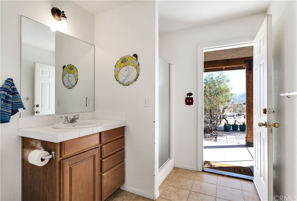 62401 Sunflower Road Joshua Tree, CA 92252 - Photo 23 of 75 a bathroom with a sink vanity and a mirror
