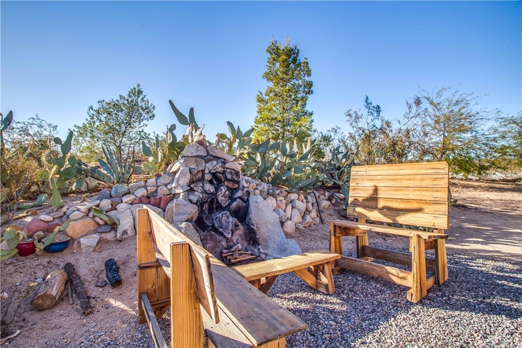 62401 Sunflower Road Joshua Tree, CA 92252 - Photo 26 of 75 a backyard of a house with table and chairs