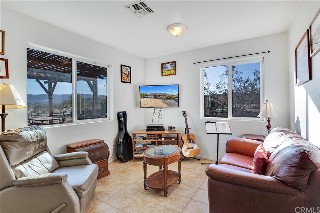62401 Sunflower Road Joshua Tree, CA 92252 - Photo 32 of 75 a living room with furniture and a large window