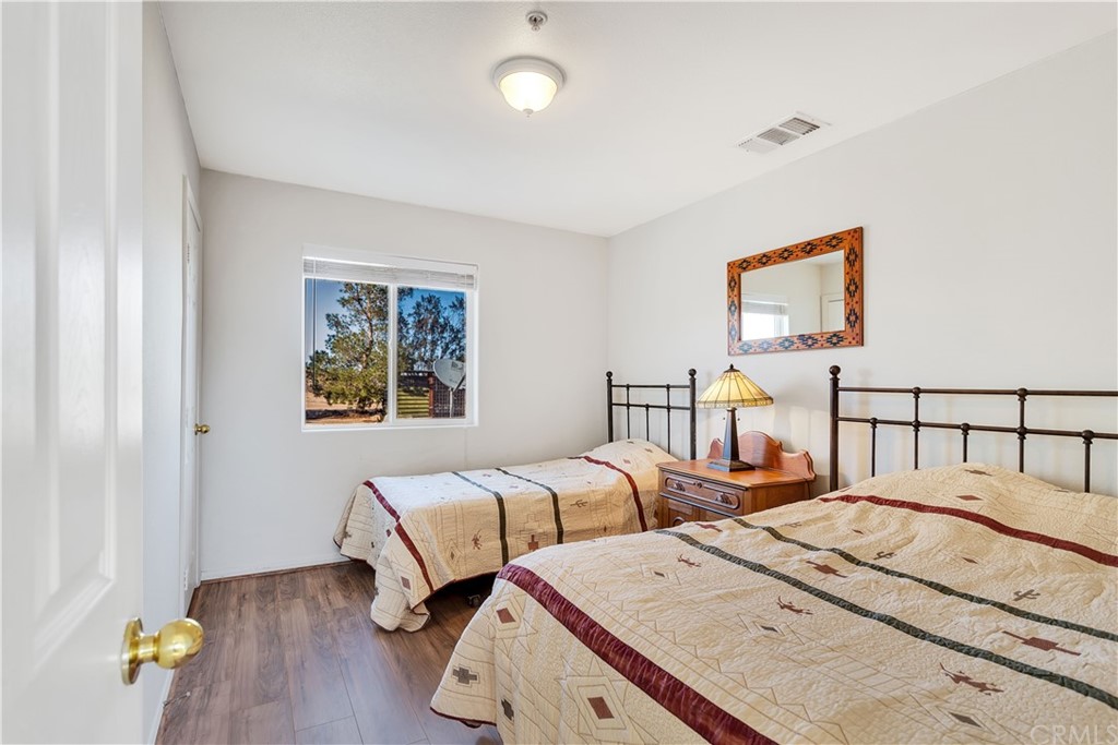 62401 Sunflower Road Joshua Tree, CA 92252 - Photo 36 of 75 a bedroom with two beds and painting on the wall