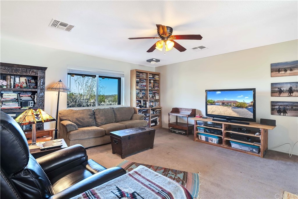 62401 Sunflower Road Joshua Tree, CA 92252 - Photo 9 of 75 a living room with furniture and a flat screen tv