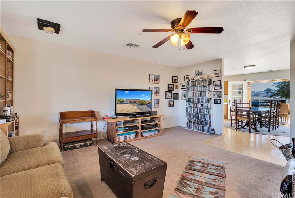 62401 Sunflower Road Joshua Tree, CA 92252 - Photo 10 of 75 a living room with furniture and a flat screen tv