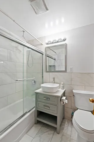 a living room with furniture a rug and a book shelf