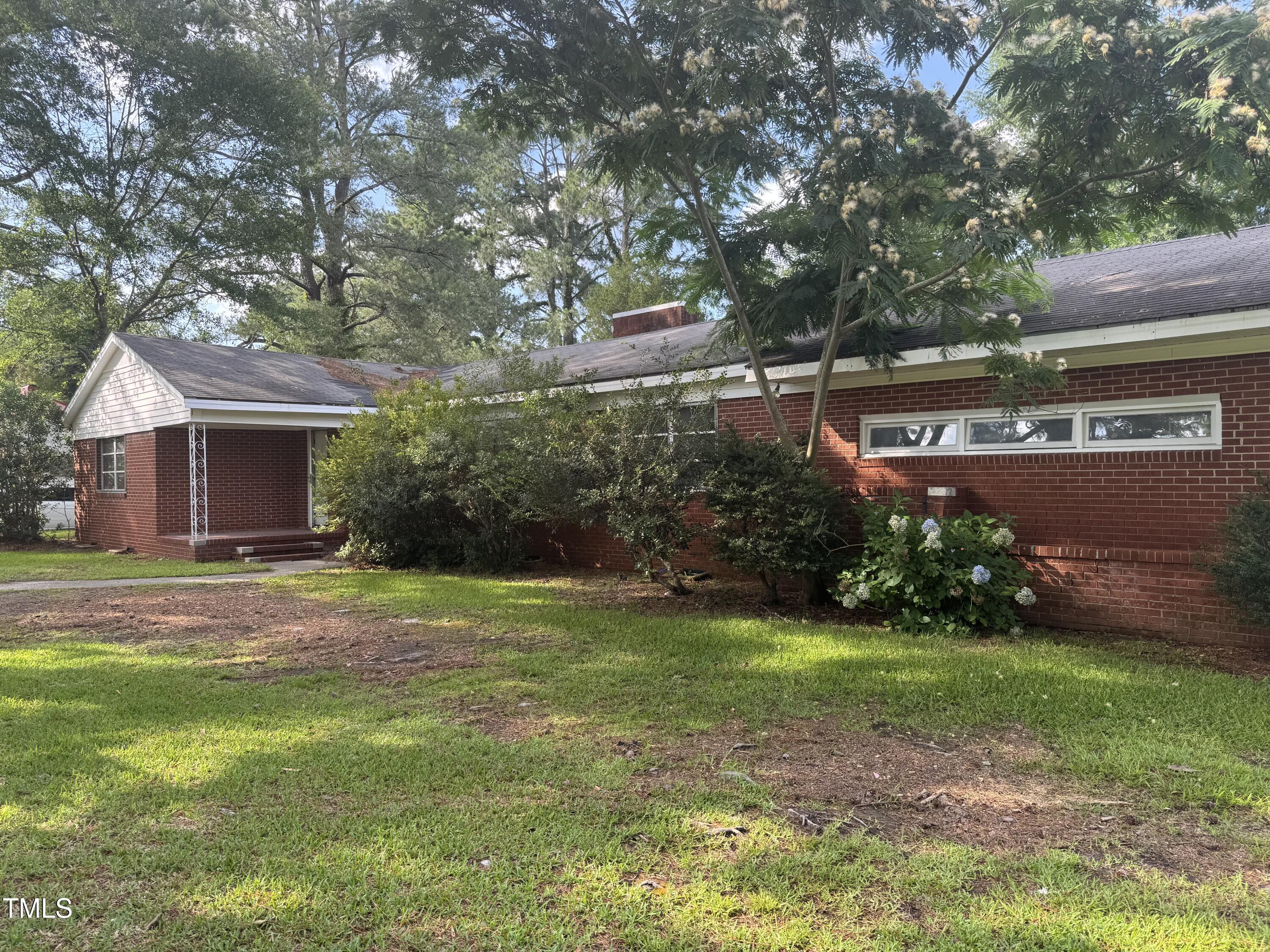 a view of a house with a yard and garage
