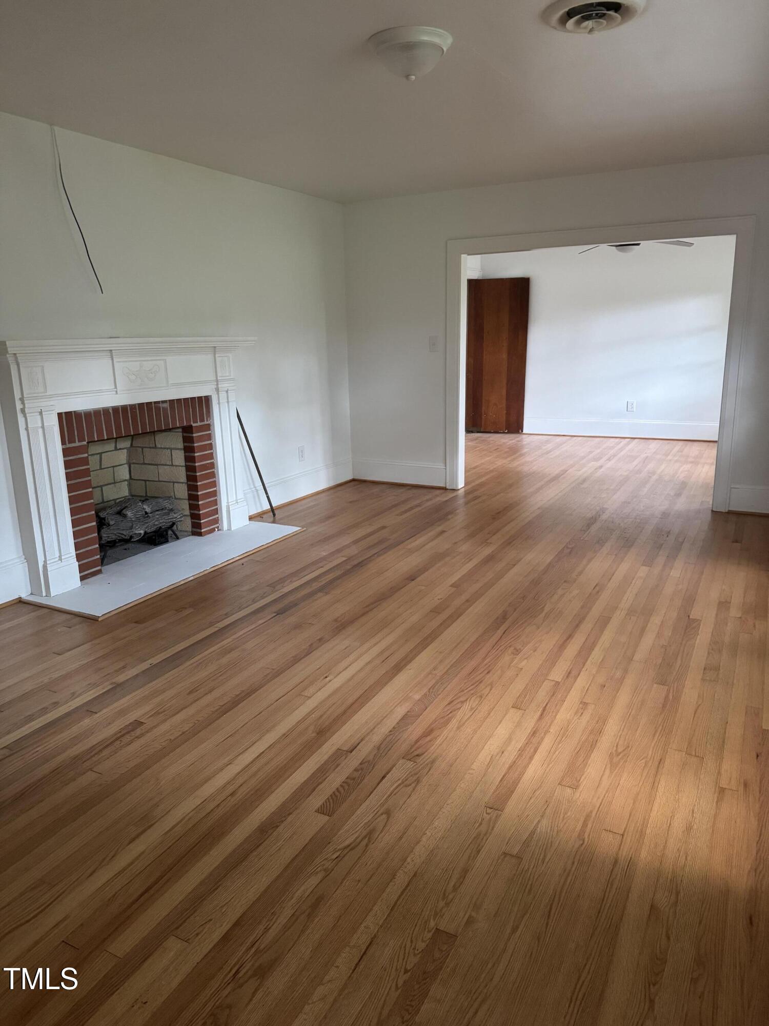 324 Bank Street Roper, NC 27970 - Photo 11 of 21 a view of an empty room with wooden floor and a window