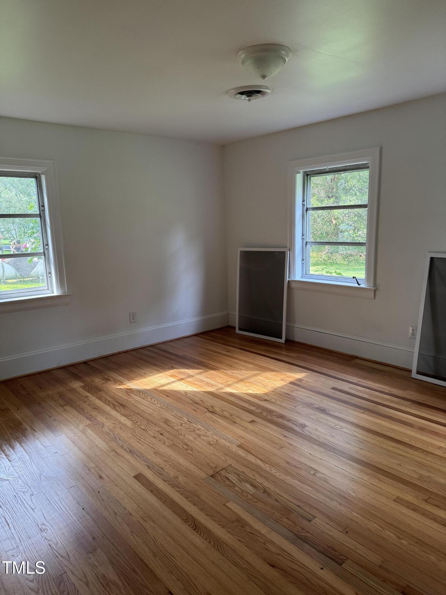 324 Bank Street Roper, NC 27970 - Photo 14 of 21 an empty room with wooden floor and windows