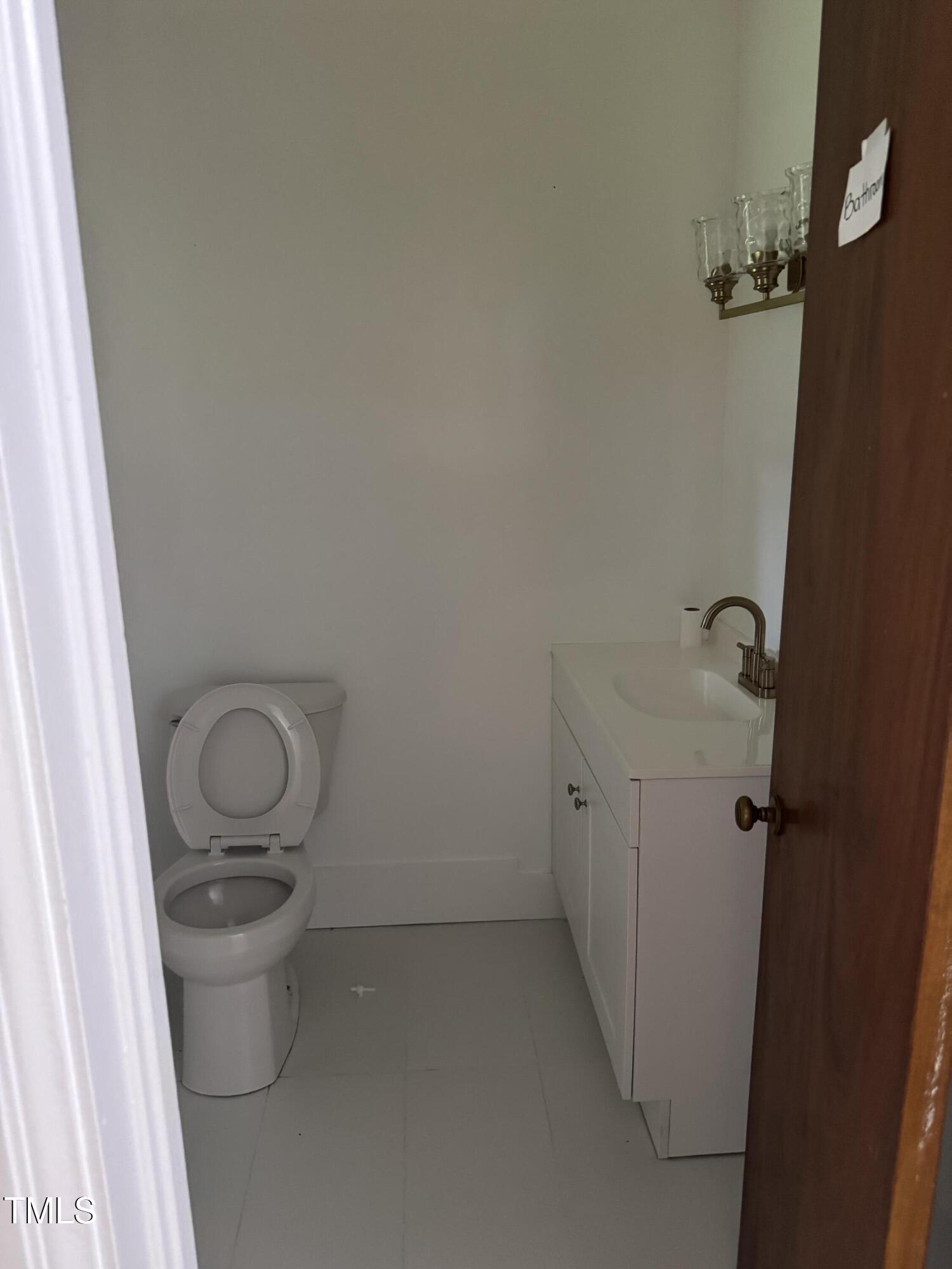 324 Bank Street Roper, NC 27970 - Photo 19 of 21 a bathroom with a granite countertop toilet and a sink