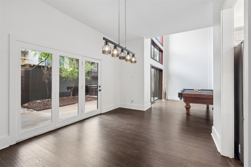 15539 Preston Road, Unit 1037 Dallas, TX 75248 - Photo 8 of 36 Hardwood-finish flooring, soaring vaulted ceilings, and a linear chandelier with glass shades