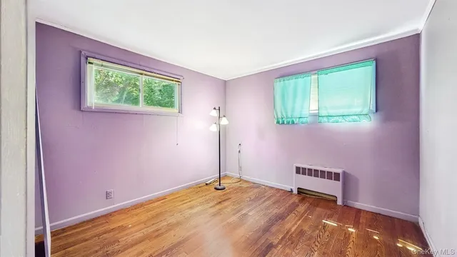 a view of a room with wooden floor and window