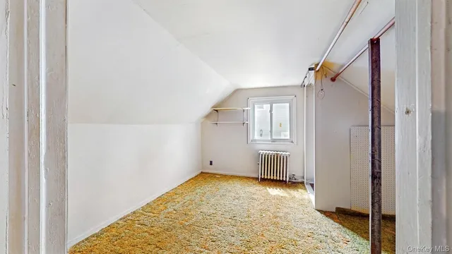 a view of a bedroom with wooden floor and windows