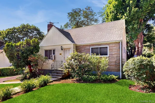 a front view of house with a garden