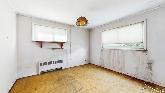 a view of an empty room with windows