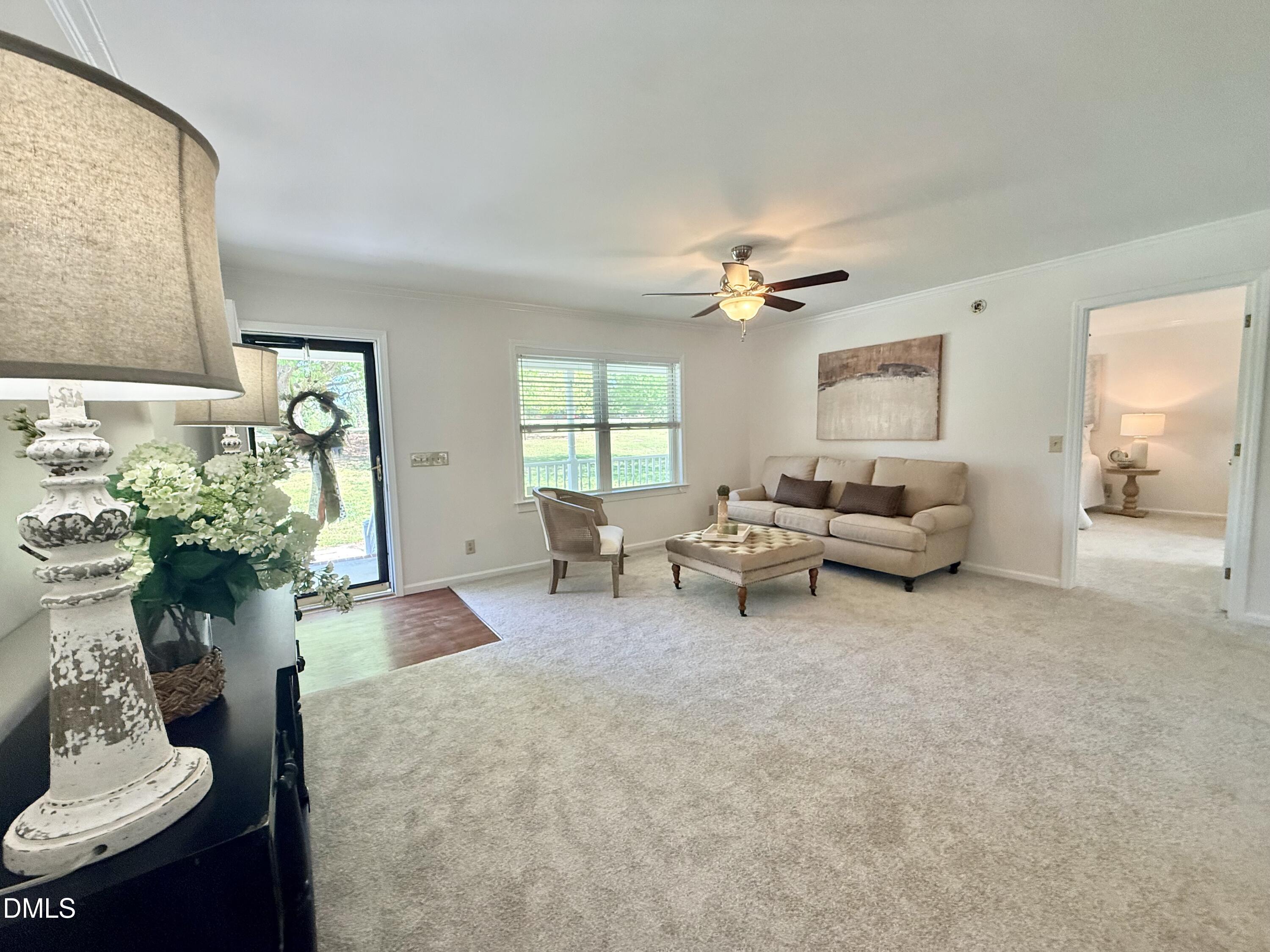 2429 Halifax Road Roxboro, NC 27573 - Photo 8 of 54 a living room with furniture and a chandelier