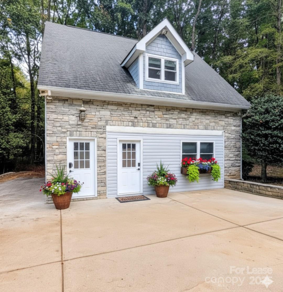 14625 Phillips Road, Unit 2 Matthews, NC 28105 - Photo 1 of 7 a front view of a house with a yard