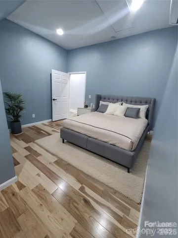 a bedroom with a bed and a potted plant