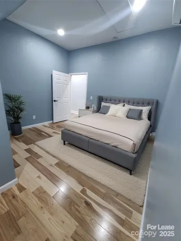 a bedroom with a bed and a potted plant