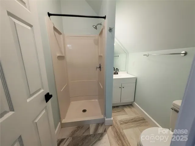 a bathroom with a shower and a toilet