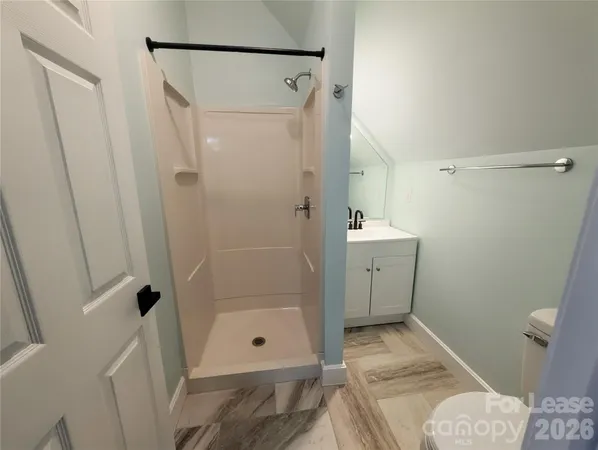 a bathroom with a shower and a toilet