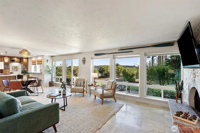 a living room with furniture tv and a floor to ceiling window