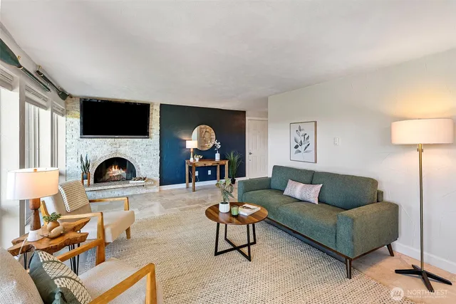 a living room with furniture a fireplace and a flat screen tv