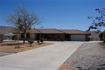 18631 Ranchero Road Hesperia, CA 92345 - Photo 1 of 1 a backyard of a house with table and chairs