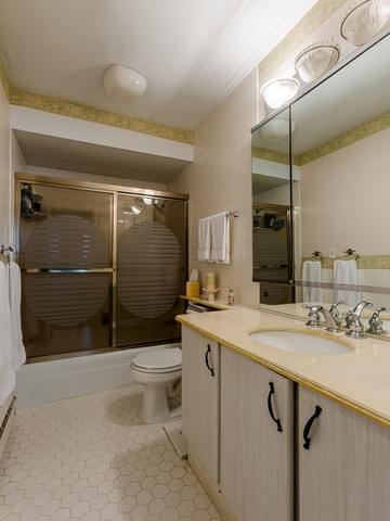 5901 North Sheridan Road, Unit 6G Chicago, IL 60660 - Photo 18 of 24 a bathroom with a sink a toilet and shower
