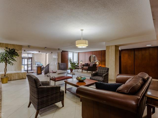 5901 North Sheridan Road, Unit 6G Chicago, IL 60660 - Photo 3 of 24 a living room with furniture a lamp and a chandelier