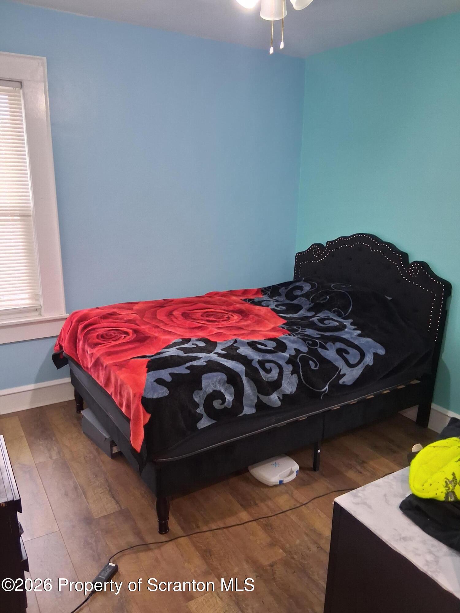 611 Moosic Street Scranton, PA 18505 - Photo 15 of 24 a bedroom with a bed window and a lamp