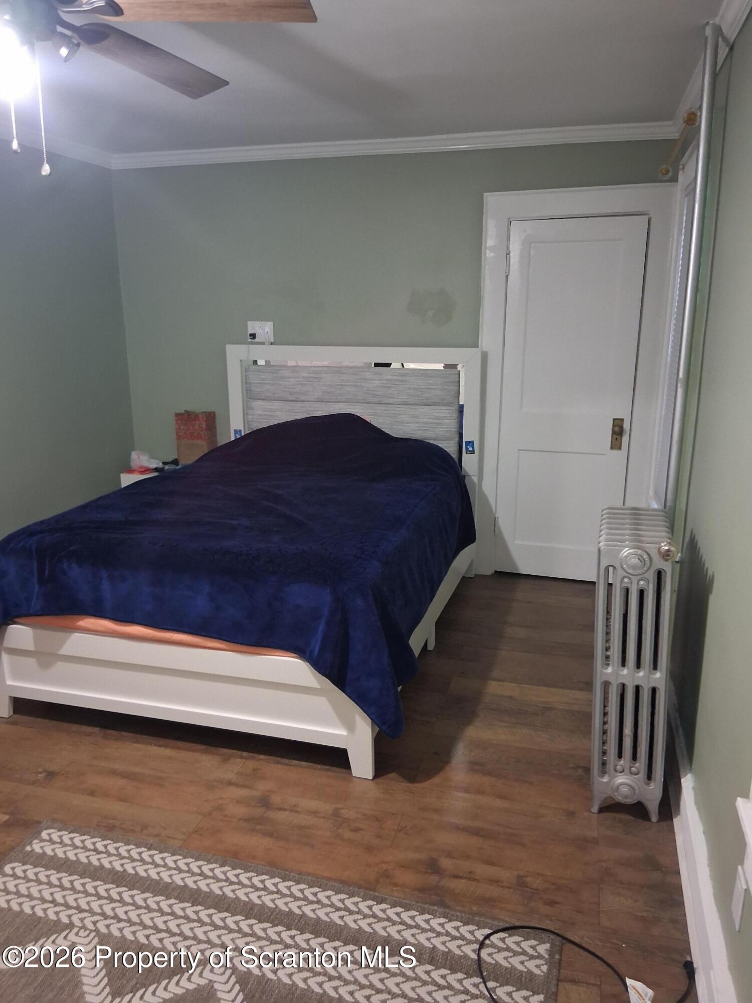 611 Moosic Street Scranton, PA 18505 - Photo 17 of 24 a bedroom with a bed and a table