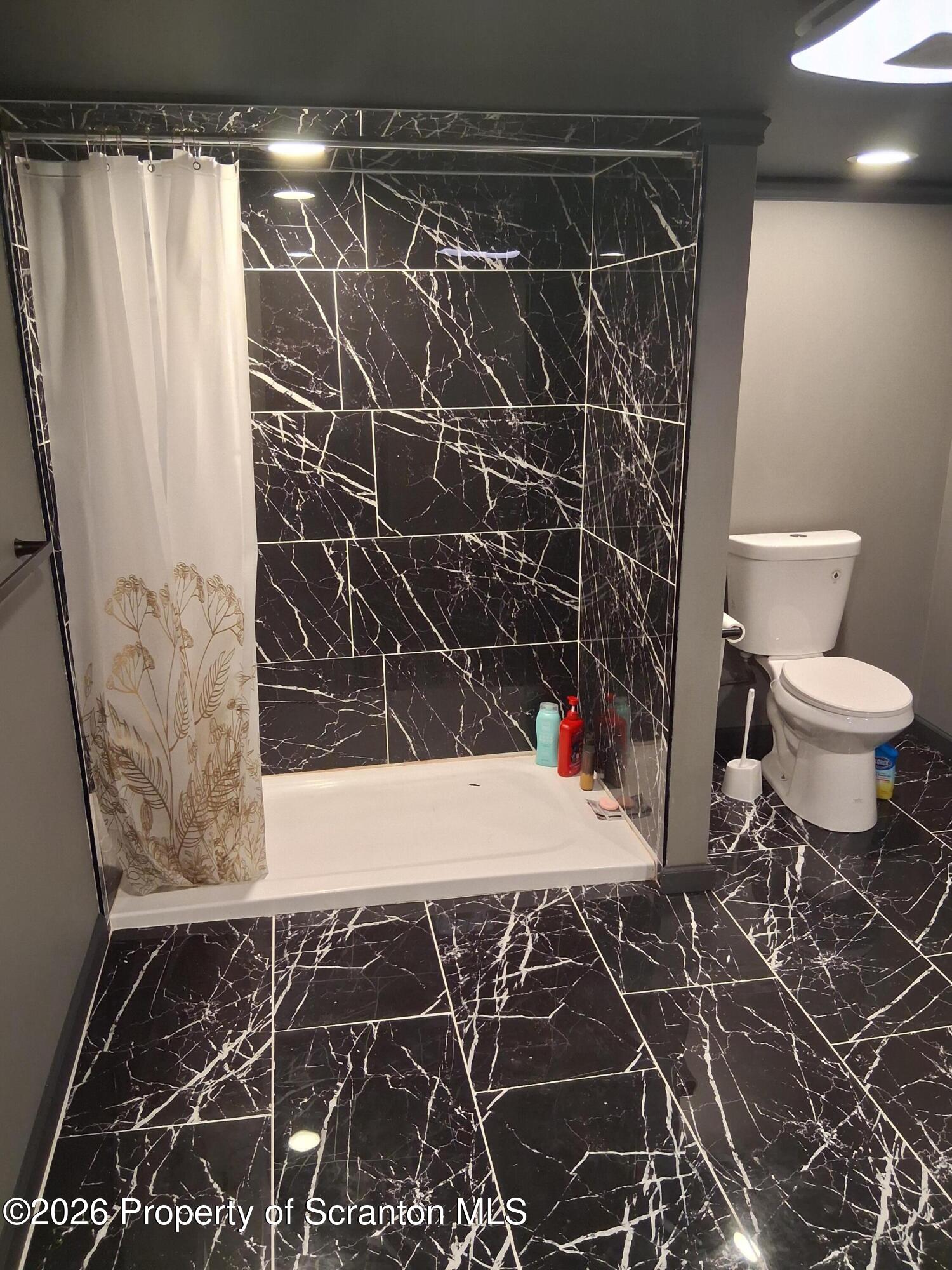611 Moosic Street Scranton, PA 18505 - Photo 19 of 24 a bathroom with a shower and a toilet