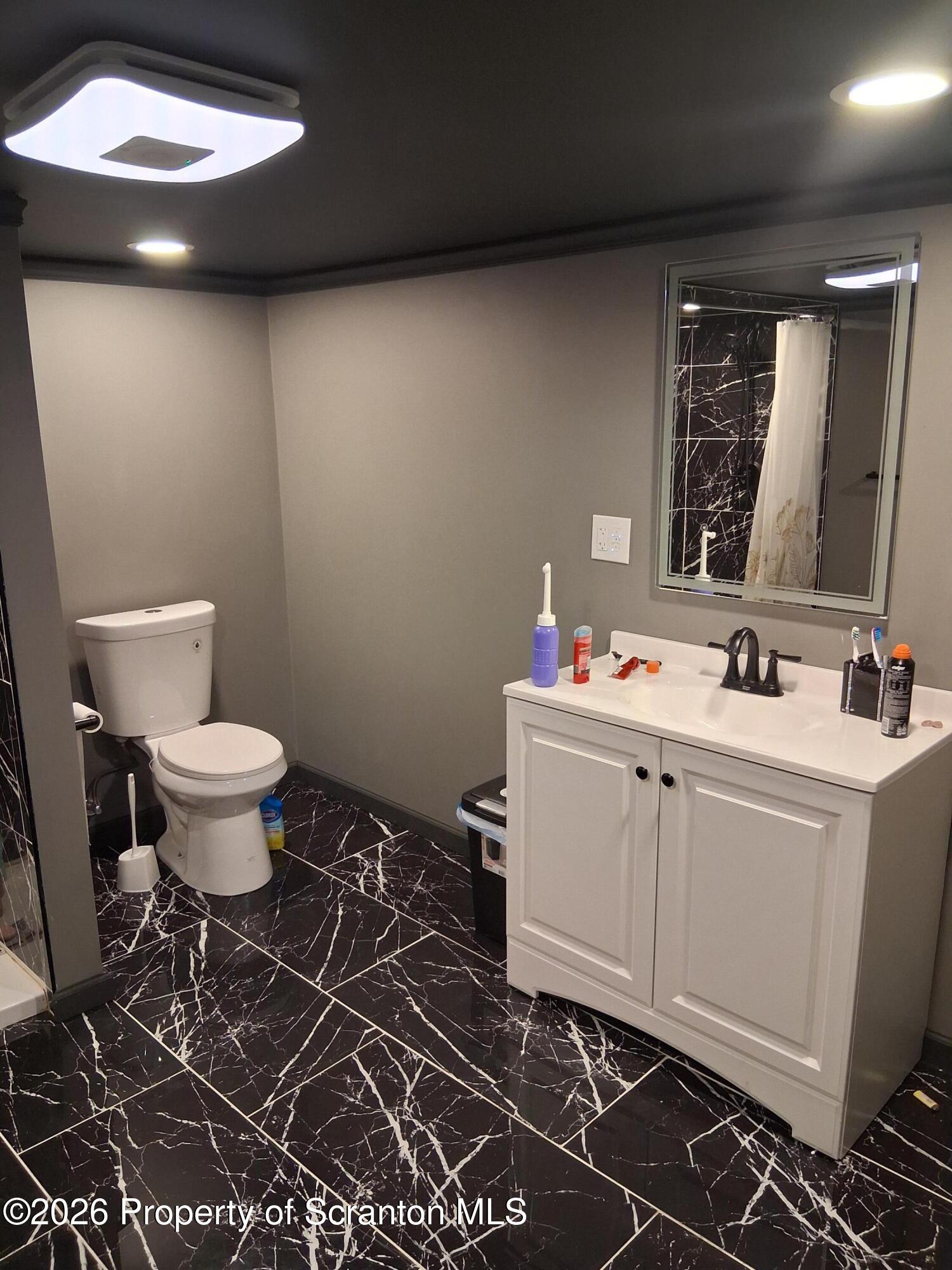 611 Moosic Street Scranton, PA 18505 - Photo 20 of 24 a bathroom with a sink toilet and a mirror