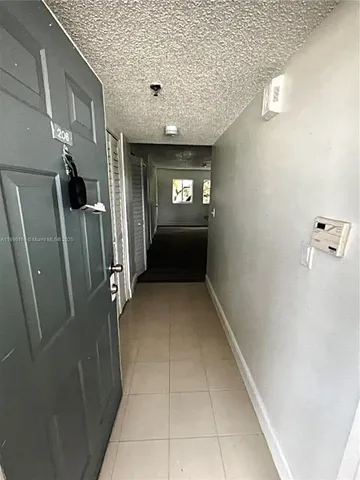 a view of a refrigerator in kitchen and utility room